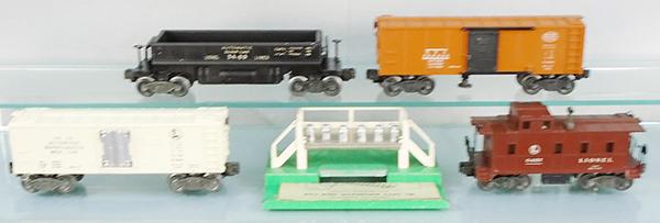 4 LIONEL FREIGHT CARS: O ga, 3469 dump car, 3464 operating NYC box car, 3472 milk car w/platform, 6457 caboose, orig boxes worn, 1 missing an end flap, C7-8.