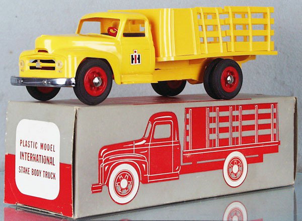 PMC 1950 INTERNATIONAL STAKE TRUCK PROMO: plastic, yellow, minor warp to stakes, orig box minor wear, C9.