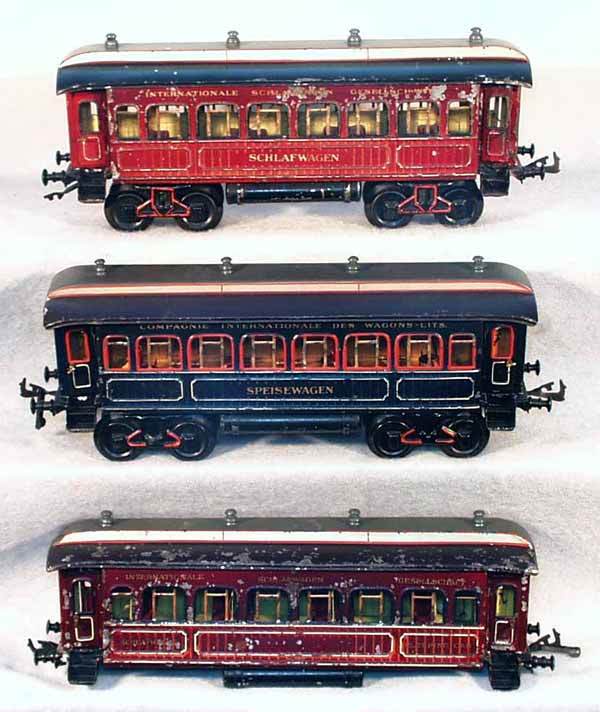 3 BING COACHES: 1 ga, handpainted tin, 13638/1 schlafwagen, heavy paint flaking, 1 coupler incom; 13556/1 spieswagen, some small touch up spots; schlafwagen, missing trucks, paint heavily flaking, all 3 have interior