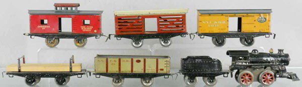 IVES TRAIN SET: O ga, #5 loco, clockwork working, 11 tender, 563 gondola, 559 lumber, some paint embellishment, 564 box car, some paint embellishment, 565 stock car, 567 caboose, C5.