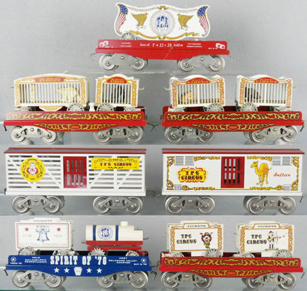 McCOY CIRCUS & TCA TRAIN SET: std ga, 5 flat cars w/circus wagons, 2 circus wagons have broken die cast wheels, 2 circus stock cars, TCA caboose not shown in photo, 5 orig boxes, C6-8.