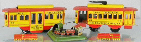 5 TOY TRAINS: litho tin, Strauss Trackless Trolley, windup working, 15" long, 2 Cracker Jack Locos, 2 1/4" long, German Crank Train, 3 1/4" long, C5-7.
