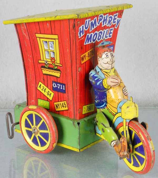 WYANDOTTE HUMPHREY MOBILE: litho tin, windup working, 7" tall, rear door intact, litho worn, wheels have solder spot on axle, missing chimney, C4-5.
