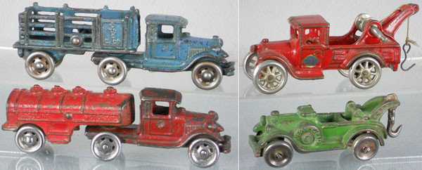 4 CAST IRON TRUCKS: painted cast iron, AC Williams Coast to Coast, 7" long, Gasoline Tanker, 7" long, Arcade Wrecker, 5 1/2" long, Hubley Service Car, 4 1/2" long, C4-5.