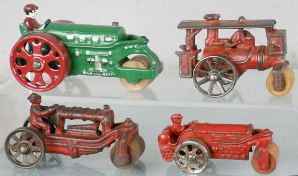 4 CAST IRON TOYS: painted cast iron, Hubley Road Roller, 4 3/4" long, repainted, rear weight broken, Roller, 3 1/2" long, Dent Roller, 4" long, Hubley Huber Road Roller, 3 1/2" long, C3-4.