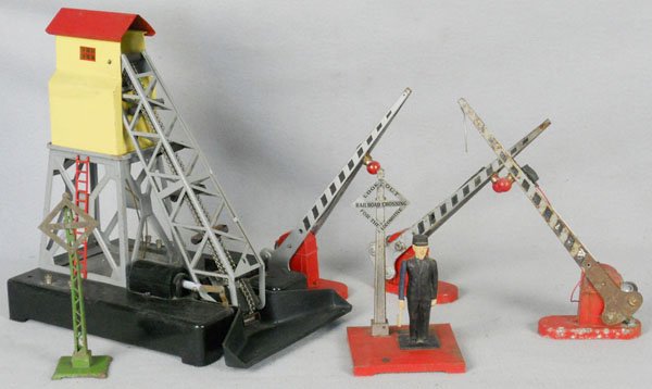 6 LIONEL ACCESSORIES: std ga, 068 crossing sign, 97 coal elevator, gray superstructure, 1045 flagman, 3 #152 crossing gates, all have some surface oxidation spots, C4-5.