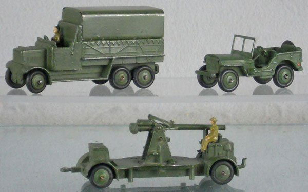 3 DINKY MILITARY VEHICLES: 151B Covered Wagon, oxidation on rear axles, 153 Jeep, oxidation on axles, 161B Anti-Aircraft Gun, oxidation on axles, C7-8.