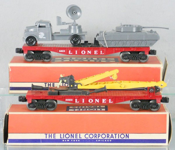 2 LIONEL FREIGHT CARS: O ga, 6803 flat w/2 military cars, no breaks, 6660 boom crane car, orig boxes minor wear, C7-8.