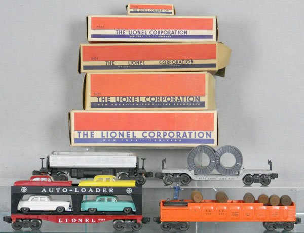 4 LIONEL FREIGHT CARS: O ga, 3459 dump car, lettering worn off on 1 side, 6561 flat w/cable reels, 6414 auto-loader, 3562-75 barrel car, orig boxes some wear, 2 rough, C5-7.