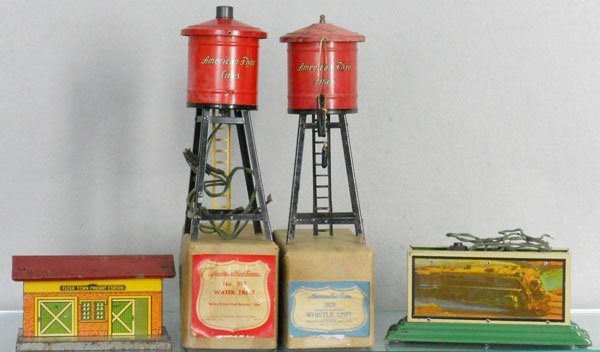 4 AMERICAN FLYER ACCESSORIES: O ga, 91 freight station, 2 #215 water tanks, 1 w/light oxidation, other has oxidation spots, missing 1 spout, 2029 whistling billboard, 2 orig boxes only, C4-6.