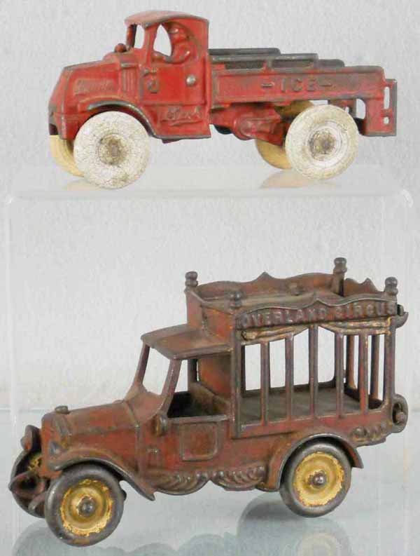 ARCADE & KENTON TRUCKS: painted cast iron, Arcade Ice Truck, 7" long, tires worn, 2 sections of handrail missing, Kenton Overland Circus Truck, 7" long, C4.