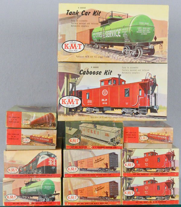 12 KMT ELECTRIC TRAIN KITS: O ga, all built, 2 gondolas, flat car, hopper, 2 box cars, 1 power loco, 2 tank cars, 3 cabooses, orig boxes minor wear, C7-8.