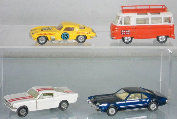 4 CORGI VEHICLES: 337 Corvette Sting Ray Stock Car, decals worn, 508 Commer Holiday Bus, 1 tire flat, 325 Ford Mustang, 264 Oldsmobile Toronado, C5-7.