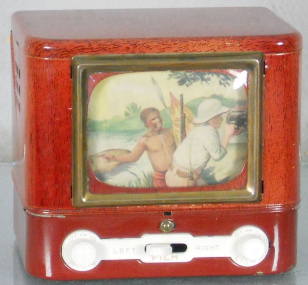 TELEVISION MUSIC BOX: Japan, litho tin, windup working, 5" wide, plays music & scene revolves, center plastic lever tip cracked, C7-8.
