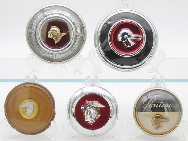 PONTIAC & MERCURY HORN BUTTONS: plastic, 3 Pontiac, 2 Mercury, 1 has chip on edge, C7-8.