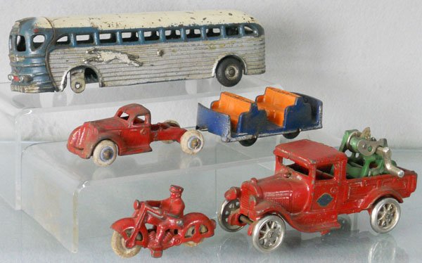 5 ARCADE VEHICLES: painted cast iron, Greyhound Bus, 9" long, missing 3 wheels, Front End Cab, 4" long, missing dump, Tram Car, missing roof, 4" long, Motorcycle, 3" long, Wrecker, boom broken, 5 3/4" long, C5.