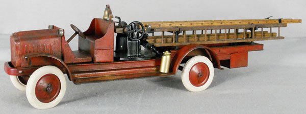 KELMET WHITE AERIAL LADDER TRUCK: painted pressed steel, 37" long, rubber tires, fire extinguishers, ladders, labels & headlights replaced, ladder mechanism working, some overall surface oxidation, C3-4.