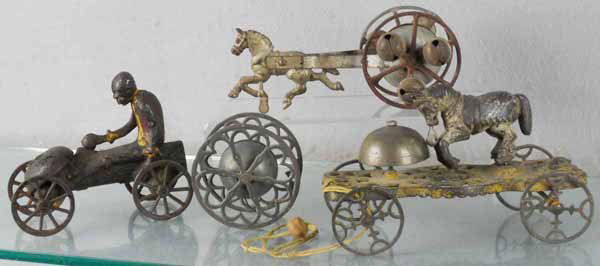4 GONG BELL TOYS: painted cast iron, Monkey & Coconut, 6" long, Horse on Wheels, 8" long, Bell on Wheels, Trick Pony, 8" long, all are worn & have paint loss, C3-4.