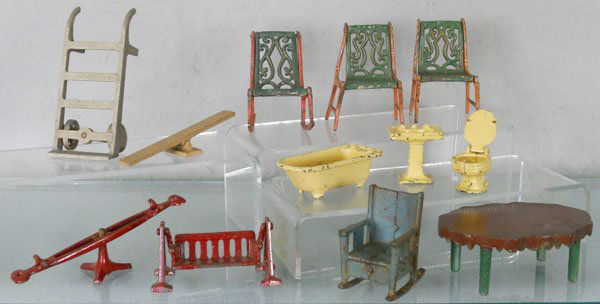 DOLL HOUSE FURNITURE LOT: painted cast iron, Hand Truck, 5" tall, 2 See Saws, 3 Chairs, 1 has a cast iron break, 3 Kilgore Bath Fixtures, Swing, Rocking Chair, 1 rocker incom, Table, repainted, by various manufacturers, C3-5.