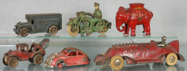 6 CAST IRON TOYS: painted cast iron, AC Williams Moving & Storage Van, 4 1/2" long, Champion Police Motorcycle, 4 3/4" long, AC Williams Elephant Still Bank, 4" tall, Hubley Tow Truck, 4 1/2" long, Hubley Airflow, 4 1/