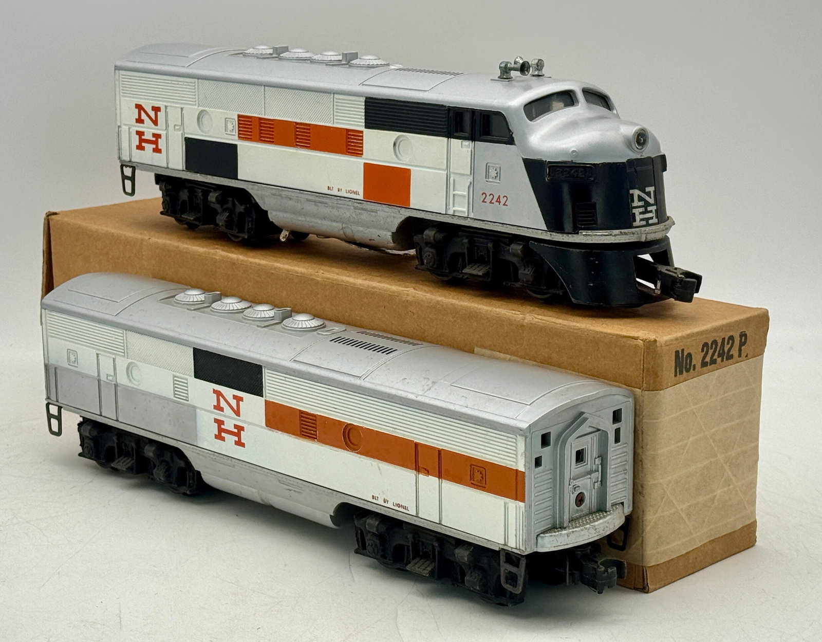 A Pair of Lionel Postwar 2242 New Haven AB Diesel F3 Locomotives: A pair of Lionel Postwar 2242 New Haven AB Diesel F3 Locomotives, comprising an F-unit style diesel locomotive numbered "2242" and a matching trailing unit. Both units bear "NH" (New Haven) railroad m