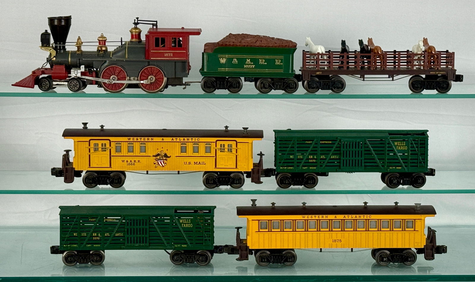 A Lionel 'The General' Model Train Set: A Lionel O Gauge 'The General' model train set, The set features a steam locomotive marked "1872," a green tender car inscribed "1872T" and a brown open stock car, also marked "1877" cont