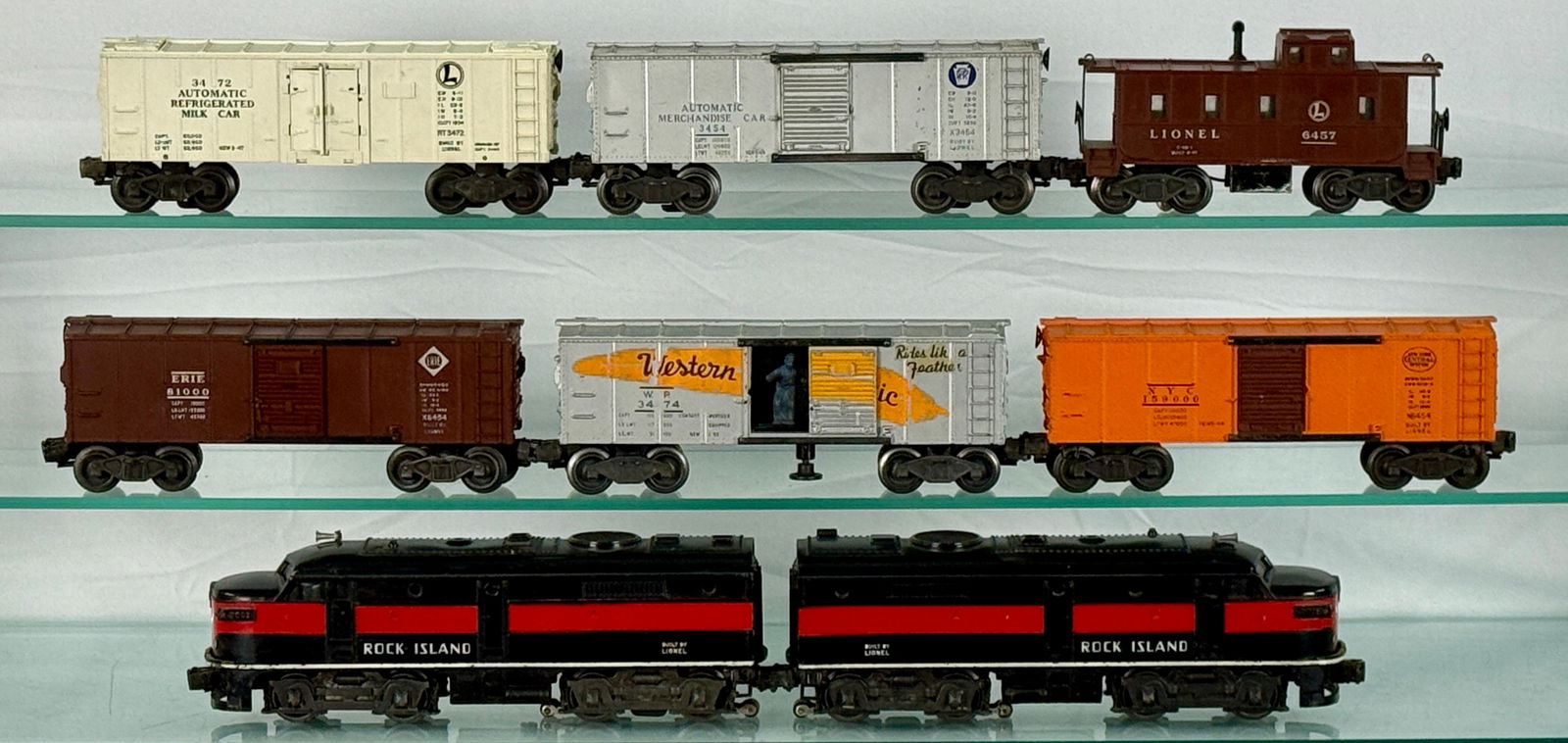 Lionel 2031 Rock Island Alco Diesel Locomotive Freight Train: Lionel 2031 Rock Island Alco Diesel AA locomotives, the accompanying freight cars include a cream "AUTOMATIC REFRIGERATED MILK CAR" (3472), a silver "AUTOMATIC MERCHANDISE CAR" (3454), a brown "LIONEL