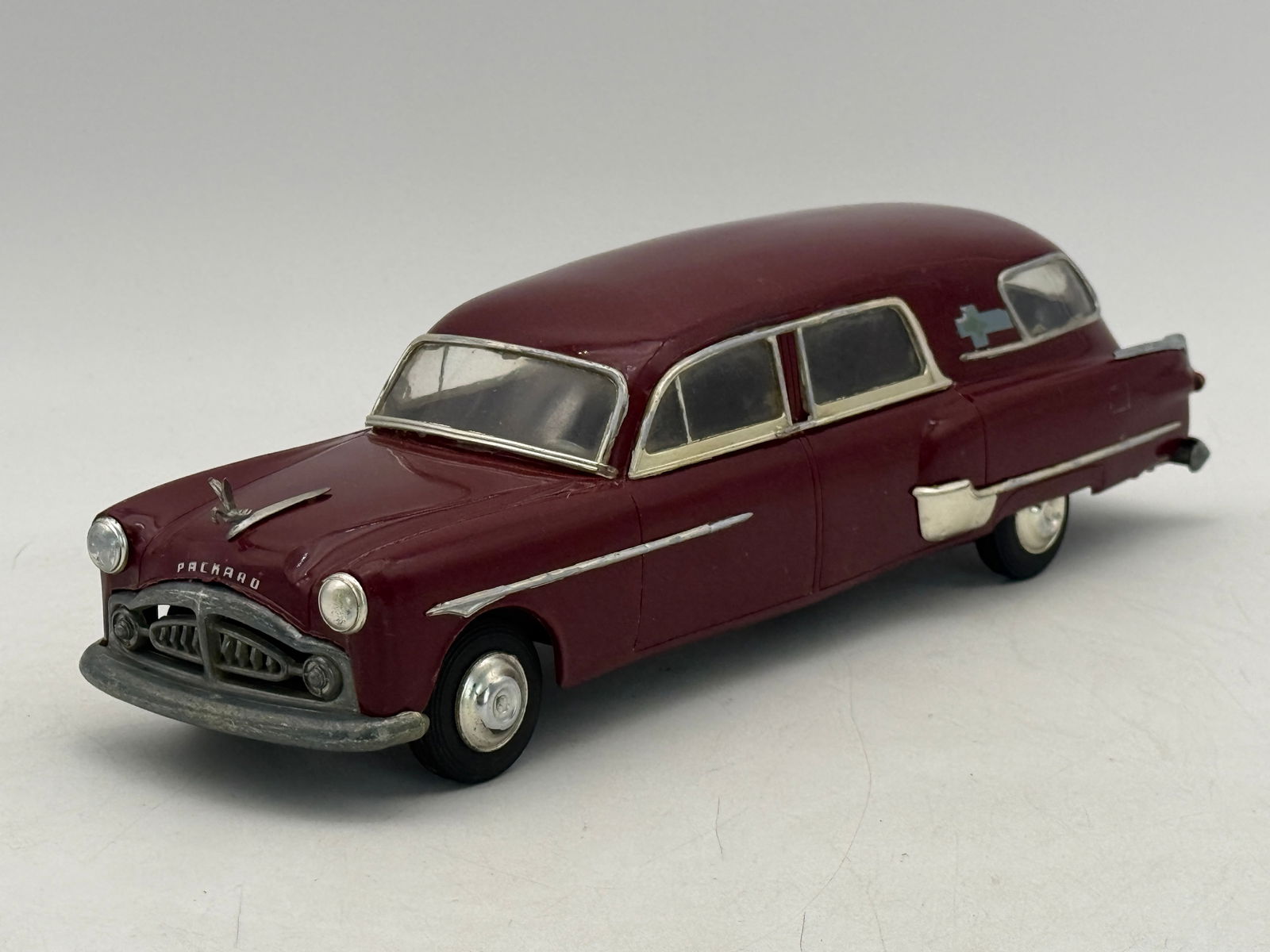 AMT 1951 Packard Ambulance Promo: Maroon Plastic 12 1/2 inches windup working but tires are rubbing on the body, C7-8.