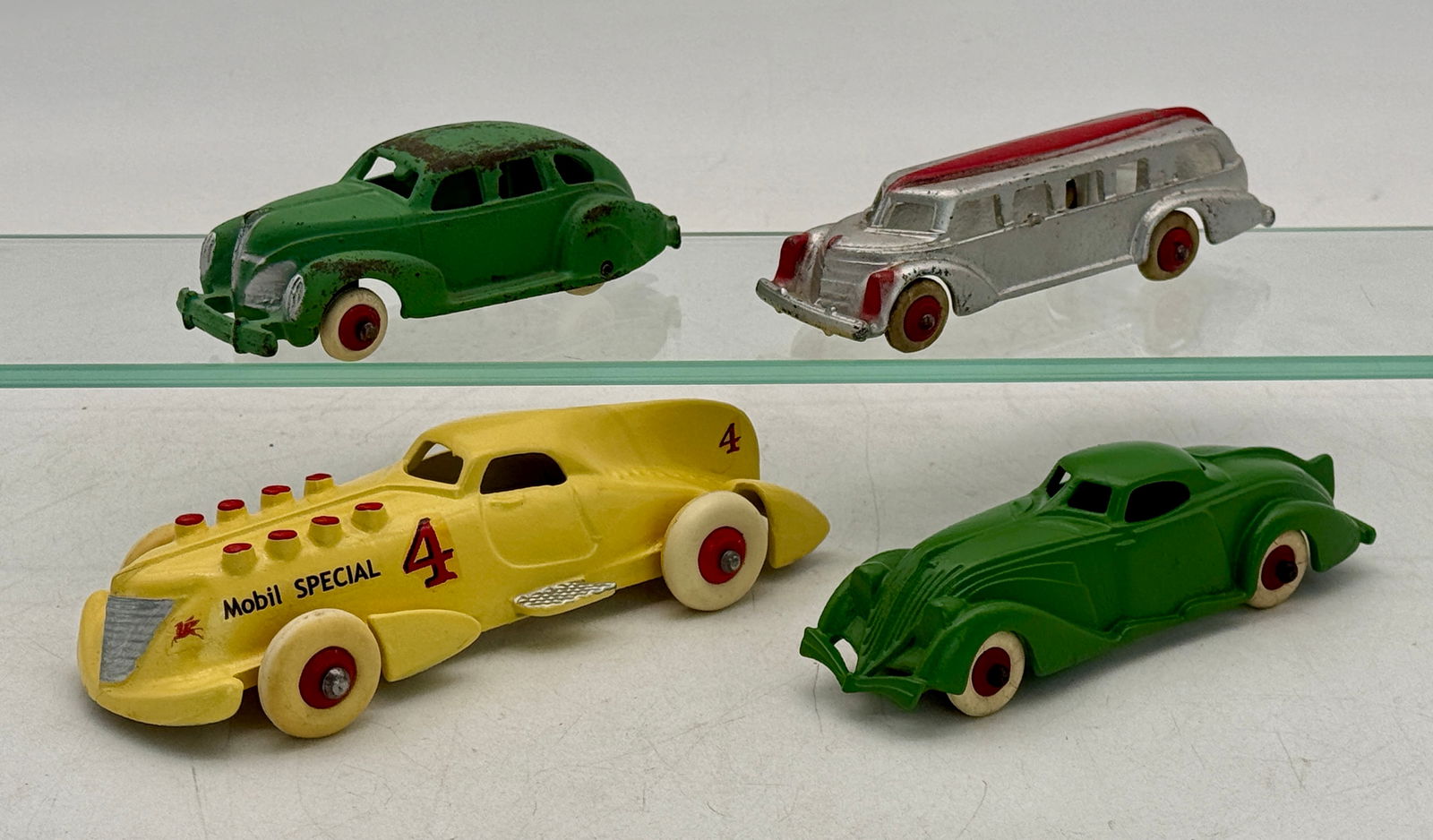 Four Hubley Cast Iron Vintage Toy Cars: Racer 7 1/4 inches restored , green coupe 6 inches, silver bus 5 3/4 inches, green sedan 5 inches, C 5â€“8