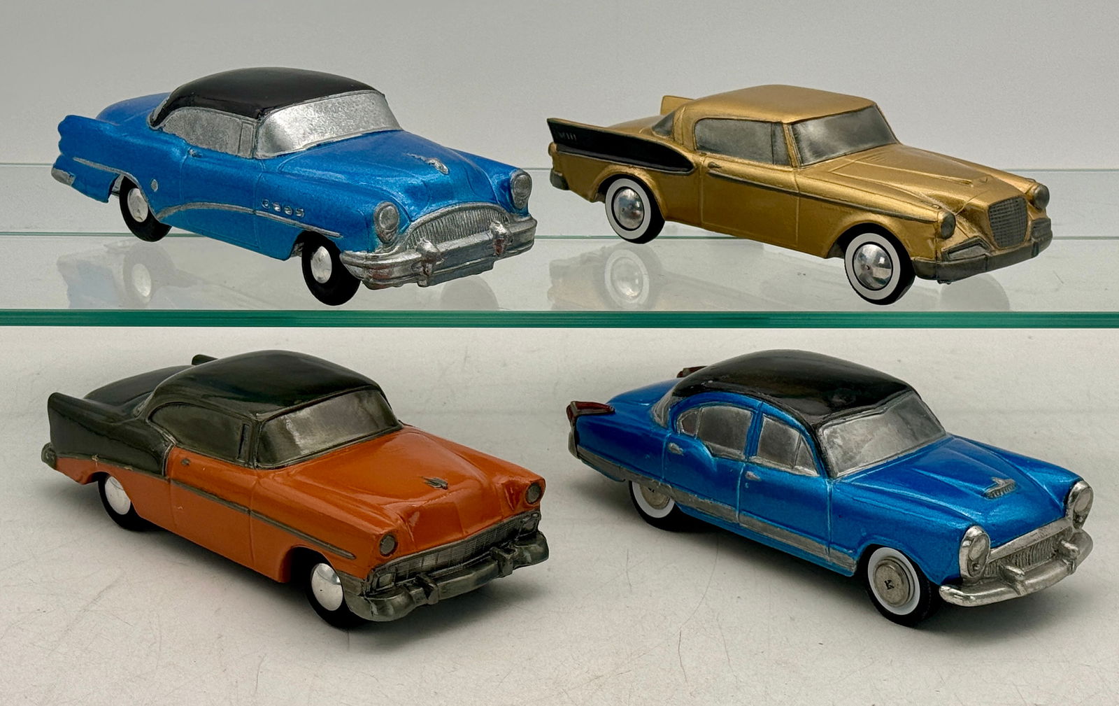 Four Banthrico AutoBank Promos: 1956 Chevrolet Belair, 1954 Buick Roadmaster, 1954 Kaiser Manhattan, 1956 Studebaker Goldenhawk, all have plastic bank slots circa 1974 C 8â€“9.