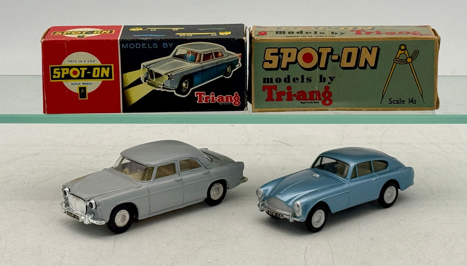 Two Spot-On by Tri-ang Model Cars: 113 Aston Martin blue, 157 SL Rover with lights gray, original boxes minor wear C 8â€“9.