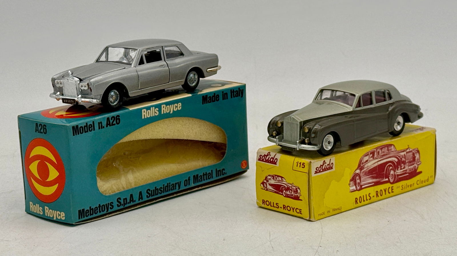 Two Mebetoys and Solido Rolls Royce Die-Cast Models: Two die-cast model cars, a silver Mebetoys Model n. A26 Rolls Royce with license plate '9500 TU' in its 'Made in Italy' box, and a two-tone grey Solido 115 Rolls-Royce 'Silver Cloud' in its 'Made in F