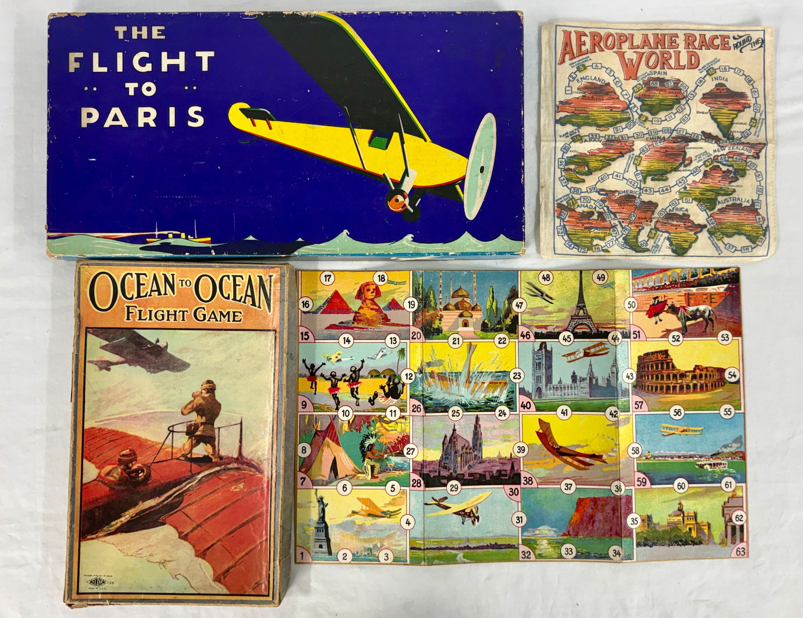 A Collection of Vintage Aviation Board Games: A collection of four vintage aviation-themed items, including 'The Flight to Paris' and 'Ocean to Ocean Flight Game' by Parker Bros Co., an 'Aeroplane Race World' game board, and a numbered cloth boar