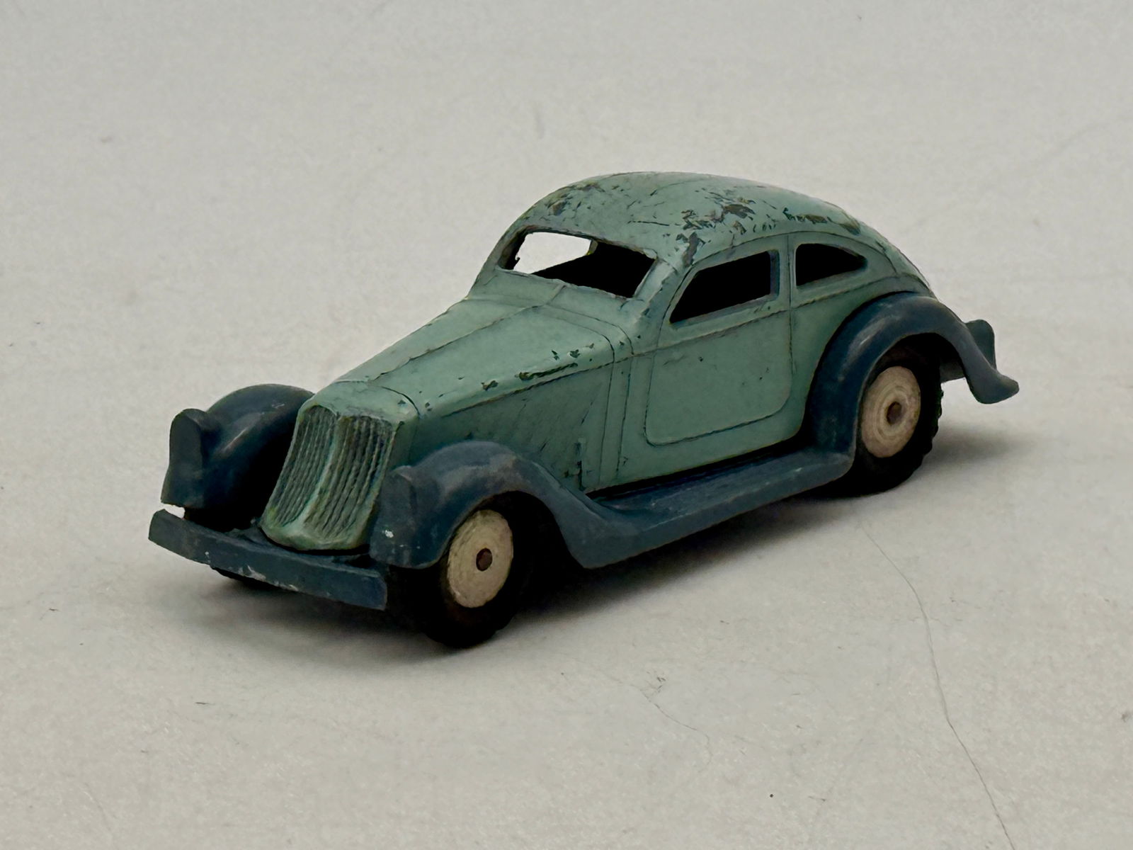 Vintage Marklin 5521/4 Coupe Toy Car: A vintage Marklin 5521/4 diecast toy car, a coupe/sedan, in faded light green/teal with darker blue fenders and chassis, marked "MARKLIN" and "Germany" on its underside, C5-6