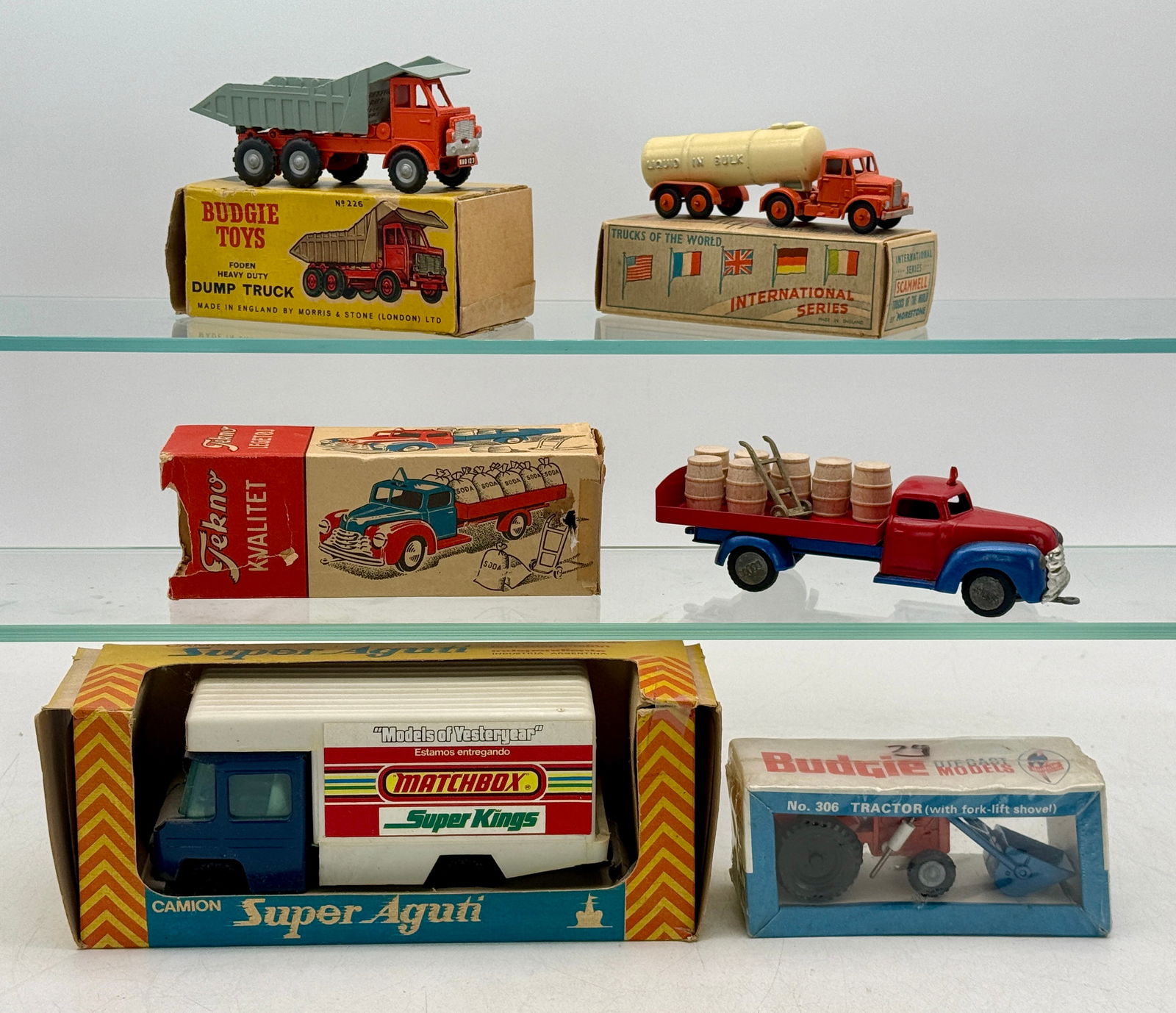 Five Diecast Trucks: Tekno 734 barrel truck, Morestone Scammel liquid tanker, Budgie 306 tractor sealed, 226 Foden dump truck, Super Aguti matchbox truck original boxes minor wear C8 to 10.