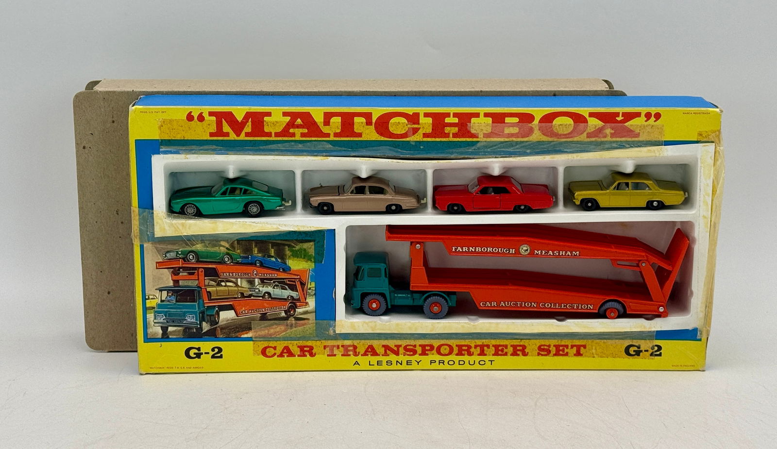 Matchbox Lesney G-2 Car Transporter Set with Five Vehicles: A Matchbox Lesney G-2 Car Transporter Set comprising one red and teal transporter labeled "FARNBOROUGH MEASHAM" and "CAR AUCTION COLLECTION" with four cars 75B2, 28C3, 22C3, 36C1, original box missing