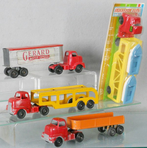 4 TOOTSIETOY TRUCKS: Boat Loader, factory sealed on orig card, IH Machinery Hauler, touch up on cab, Gerard Motor Express, missing rear doors, Car Carrier, missing cars & ramp, C5-9.