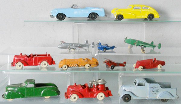 12 SLUSH VEHICLES: Convertible, 6 1/2" long, Sedan, 5 3/4" long, 2 Hubley Airplanes, 5" wingspan, 2 small Airplanes, 2 1/2" wingspans, 2 Hubley Fire Trucks, 4" long, Jane Francis Pick Up, 5" long, Erie Ice Truck, 5" lon