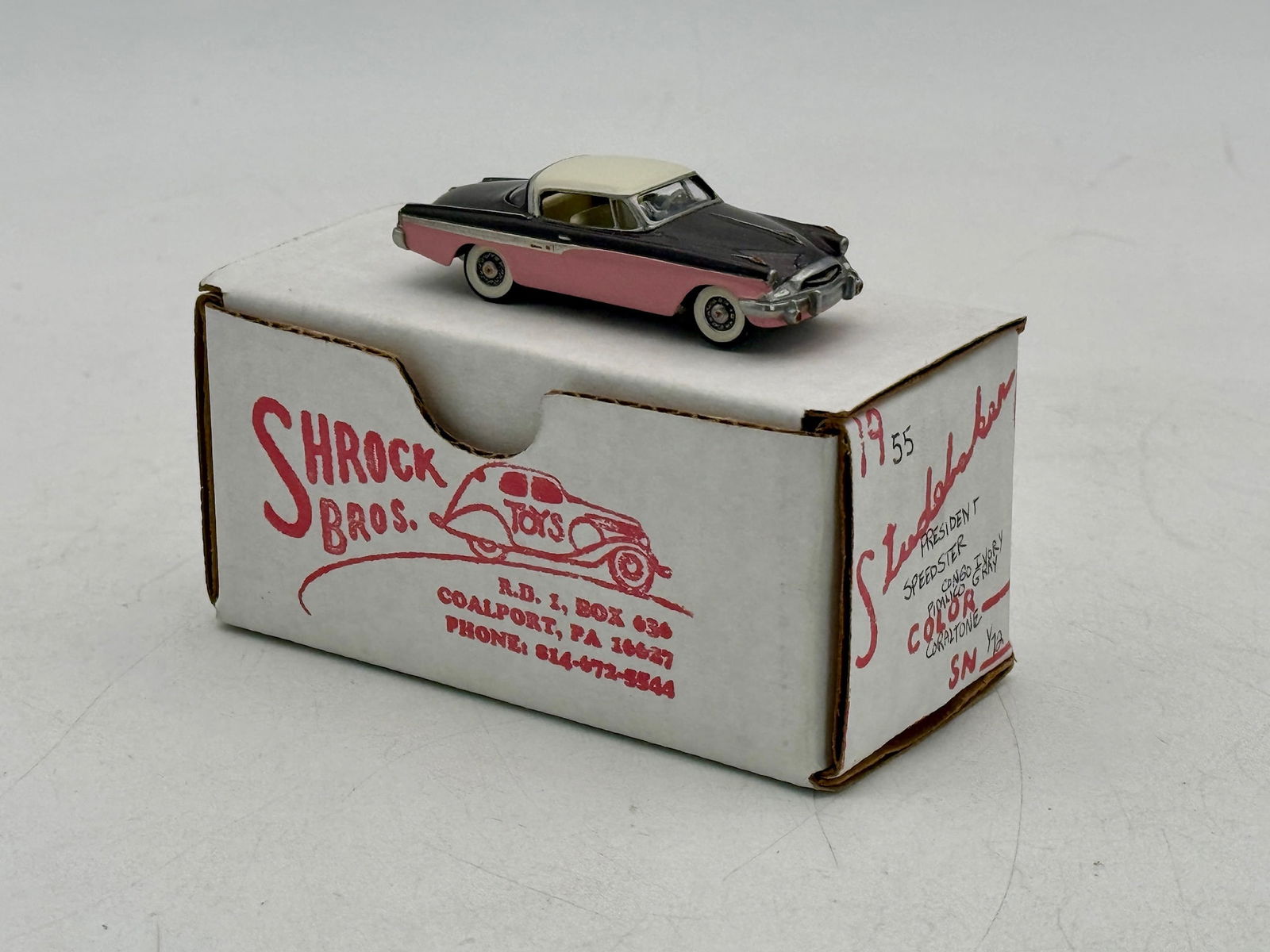 Shrock Bros. Toys 1955 Studebaker President Speedster Model Car: A 1:72 scale model of a 1955 Studebaker President Speedster finished in Congo Ivory, Pimlico Grey, and Coraltone with its original labeled box. C9