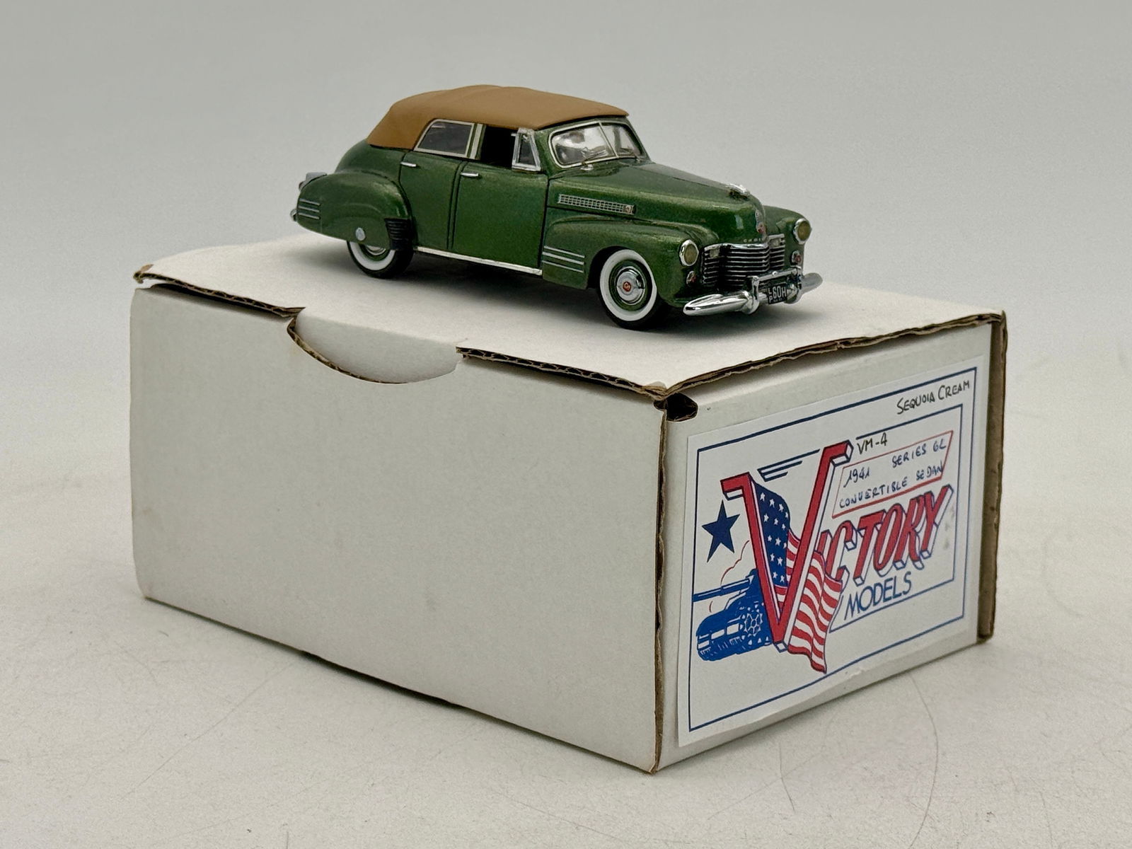 Victory Models VM-4 1941 Cadillac Series 62 Convertible Sedan: A resin 1/43 scale green and tan 1941 Cadillac Series 62 Convertible Sedan model car by Victory Models with its original box. Green/cream. OB and inserts C9