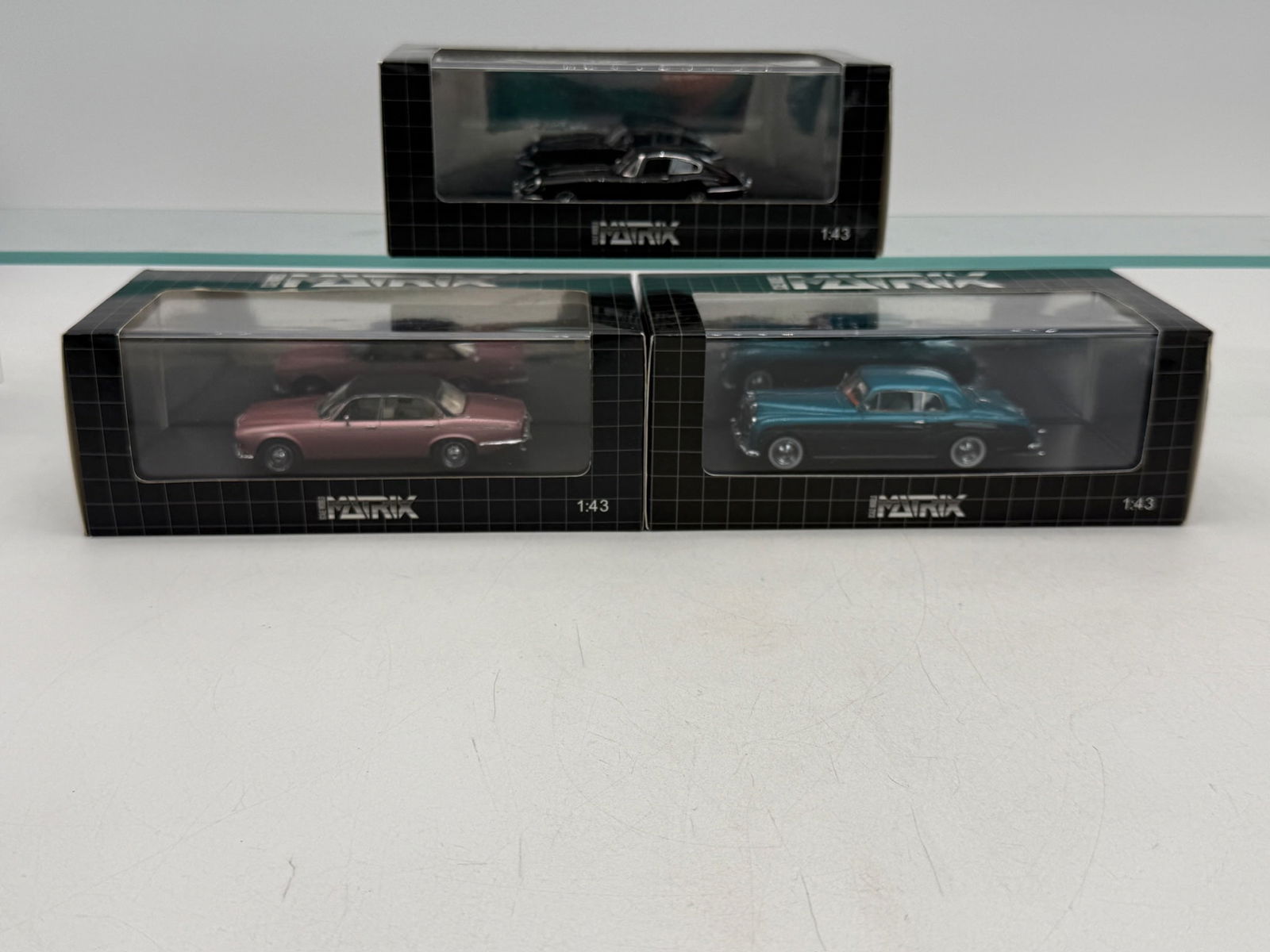 3 Matrix Scale Models 1:43 Scale resin Vehicles: 3 1:43 scale model vehicles including a pink 1973 Daimler Double Six MX 40402â€“011, a black Jaguar E-Type MX 11001â€“052, and a 1956 Bentley Packward (missing label) , all in original