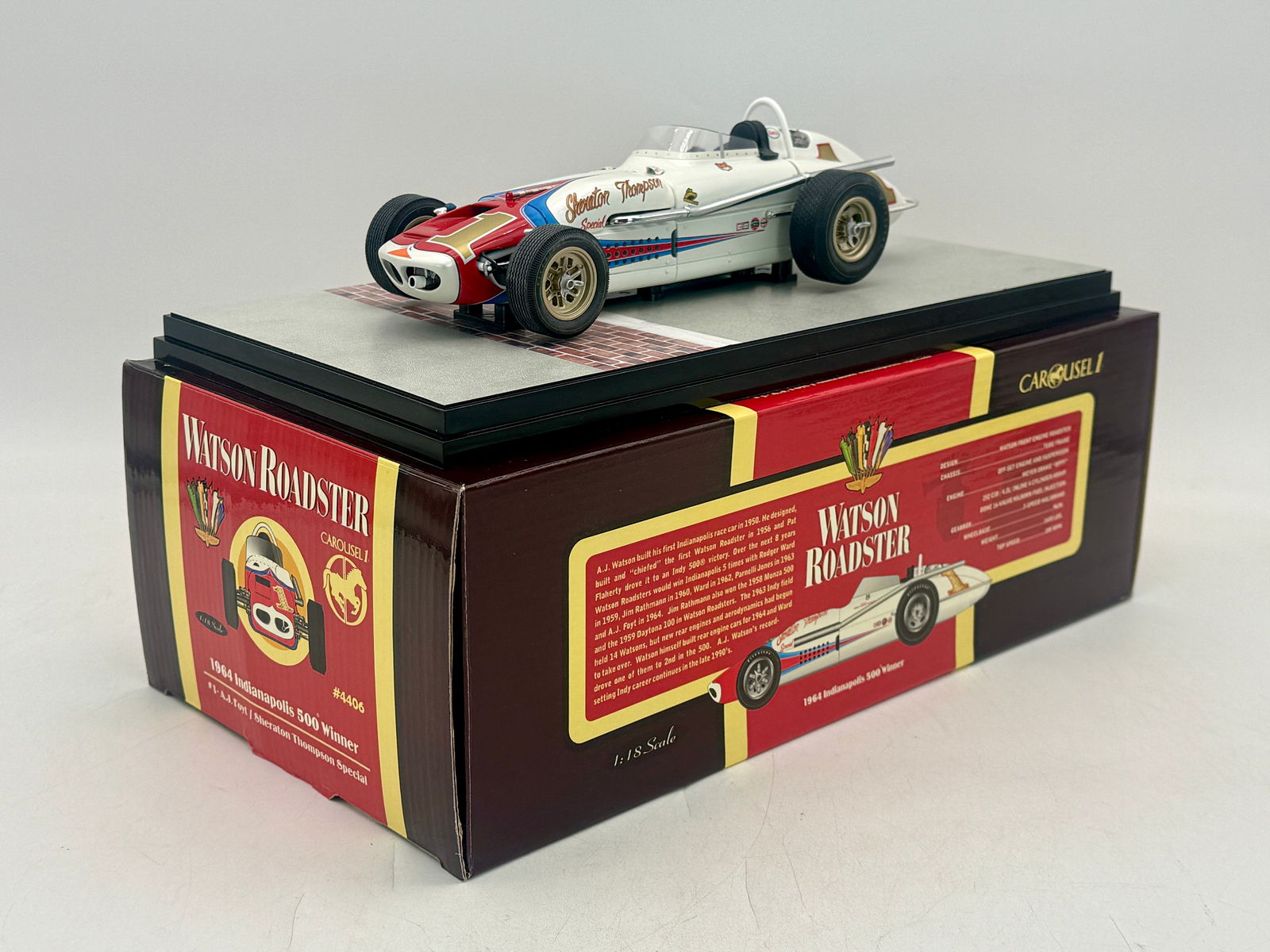 Carousel 1 1:18 4406 1964 Indy 500 Winner Watson Roadster: A Carousel 1 1:18 scale die-cast model of the #4406 white, red, and blue 1964 Indianapolis 500 winner Watson Roadster Sheraton Thompson Special driven by A.J. Foyt, including the original box, white o