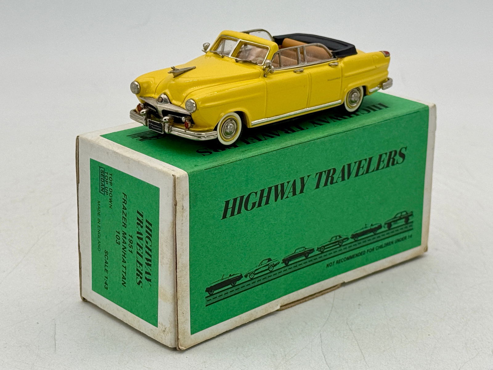 Highway Travelers 1:43 Scale 1951 Frazer Manhattan Convertible No. 103: White metal, 5 inches long, yellow 1:43 scale model of a 1951 Frazer Manhattan convertible featuring a tan interior and original green and white box. OB C9