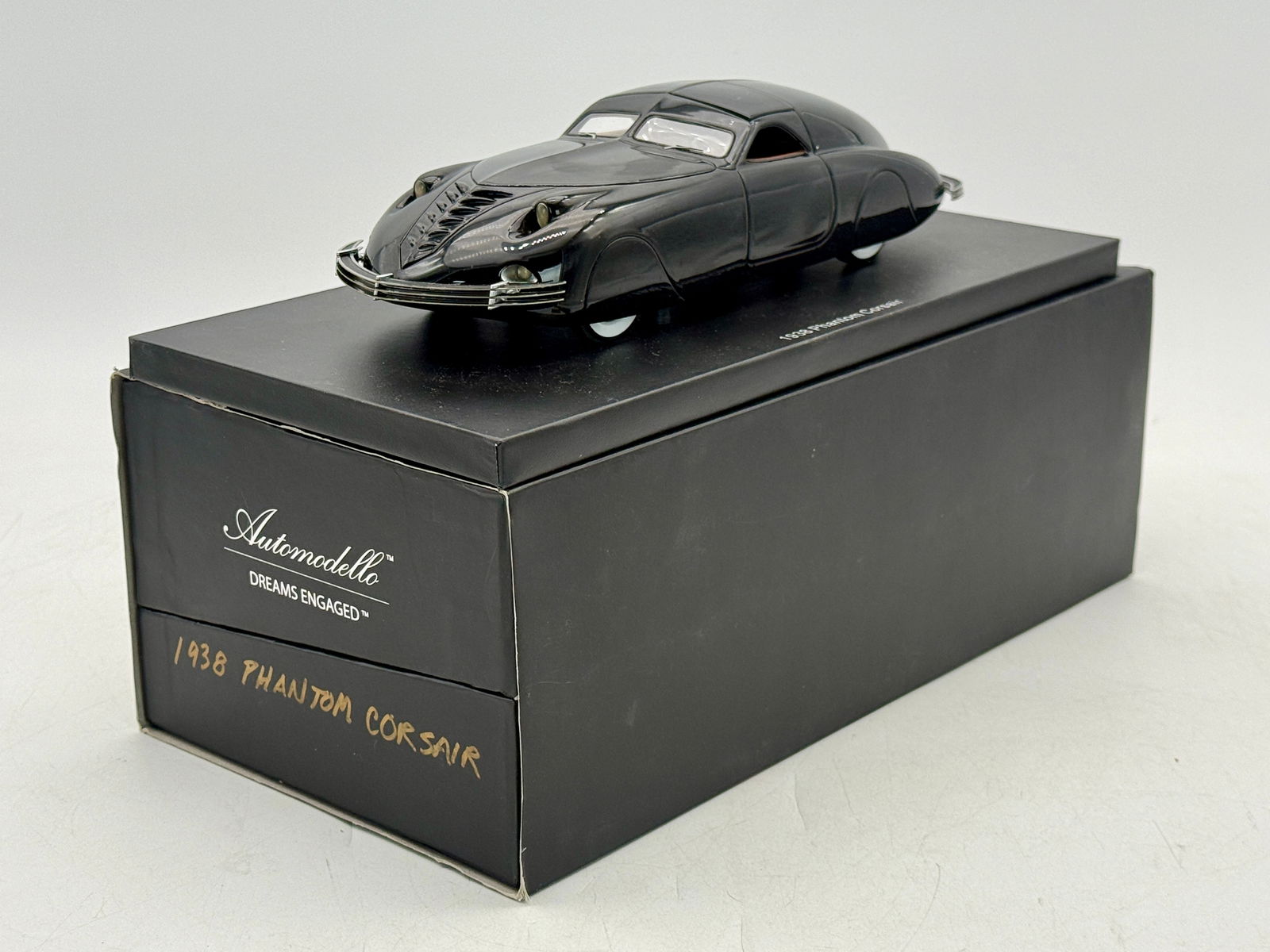 Automodello 1938 Phantom Corsair Scale Model Car: A black 1:24 scale model of a 1938 Phantom Corsair by Automodello, resin, #56 of 299, 10" long featuring a removable roof panel. with paperwork, OB and inserts mw C9