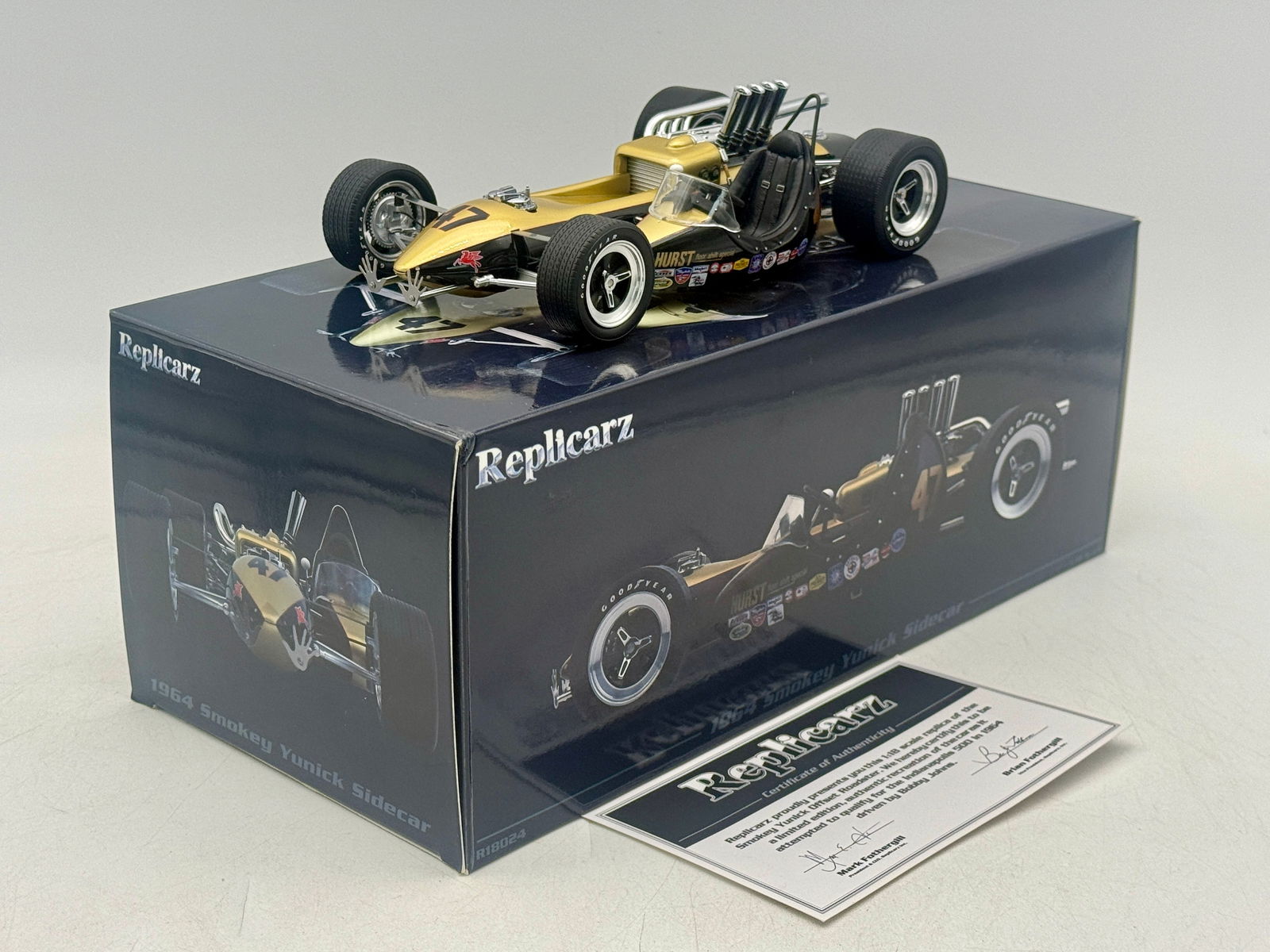 Replicarz R18024 1964 Smokey Yunick Sidecar Hurst Special Model: A gold and black 1:18 scale model of the 1964 Smokey Yunick Sidecar race car featuring Hurst floor shift special markings, original box, and certificate of authenticity. 8.5" long OB C9.