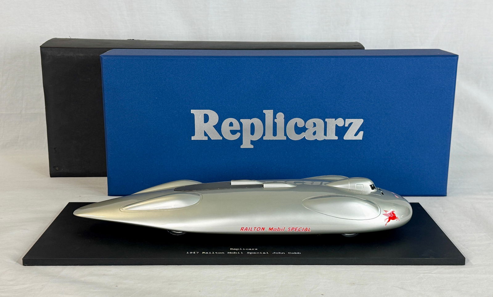 Replicarz R18502 1947 Railton Mobil Special John Cobb Model Car: A 1:18 scale silver Replicarz model of the 1947 Railton Mobil Special land speed record car driven by John Cobb, featuring a black display base and original blue box. Resin 19" long on wood plinth,