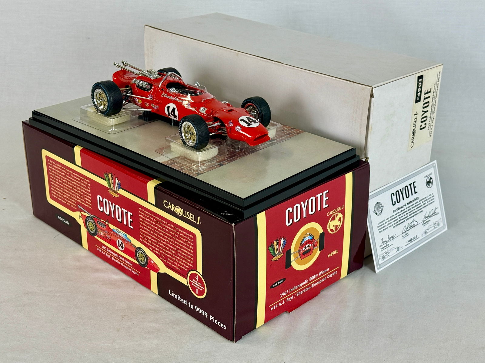 Carousel 1 4901 1967 Indy 500 Winner Coyote: A red Carousel 1 1:18 scale die-cast model of the #14 A.J. Foyt Sheraton-Thompson Coyote 1967 Indianapolis 500 winner with original box and certificate of authenticity. 9" long OB and insert,