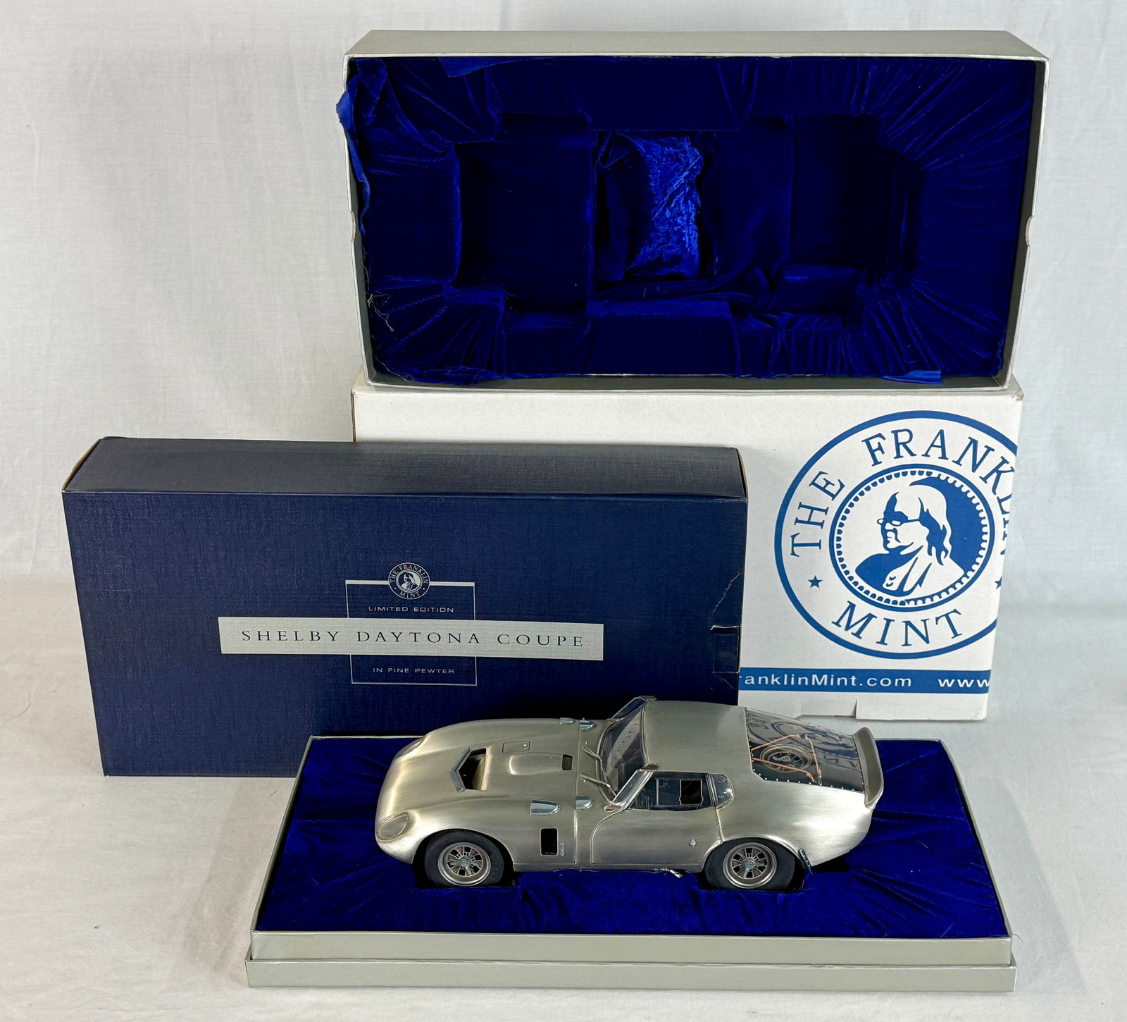 Franklin Mint Pewter Shelby Daytona Coupe: A 1:12 scale fine pewter model of a Shelby Daytona Coupe by The Franklin Mint, presented in its original velvet-lined display base and branded packaging. 0825 out of 1000, 13" long OB and inserts,