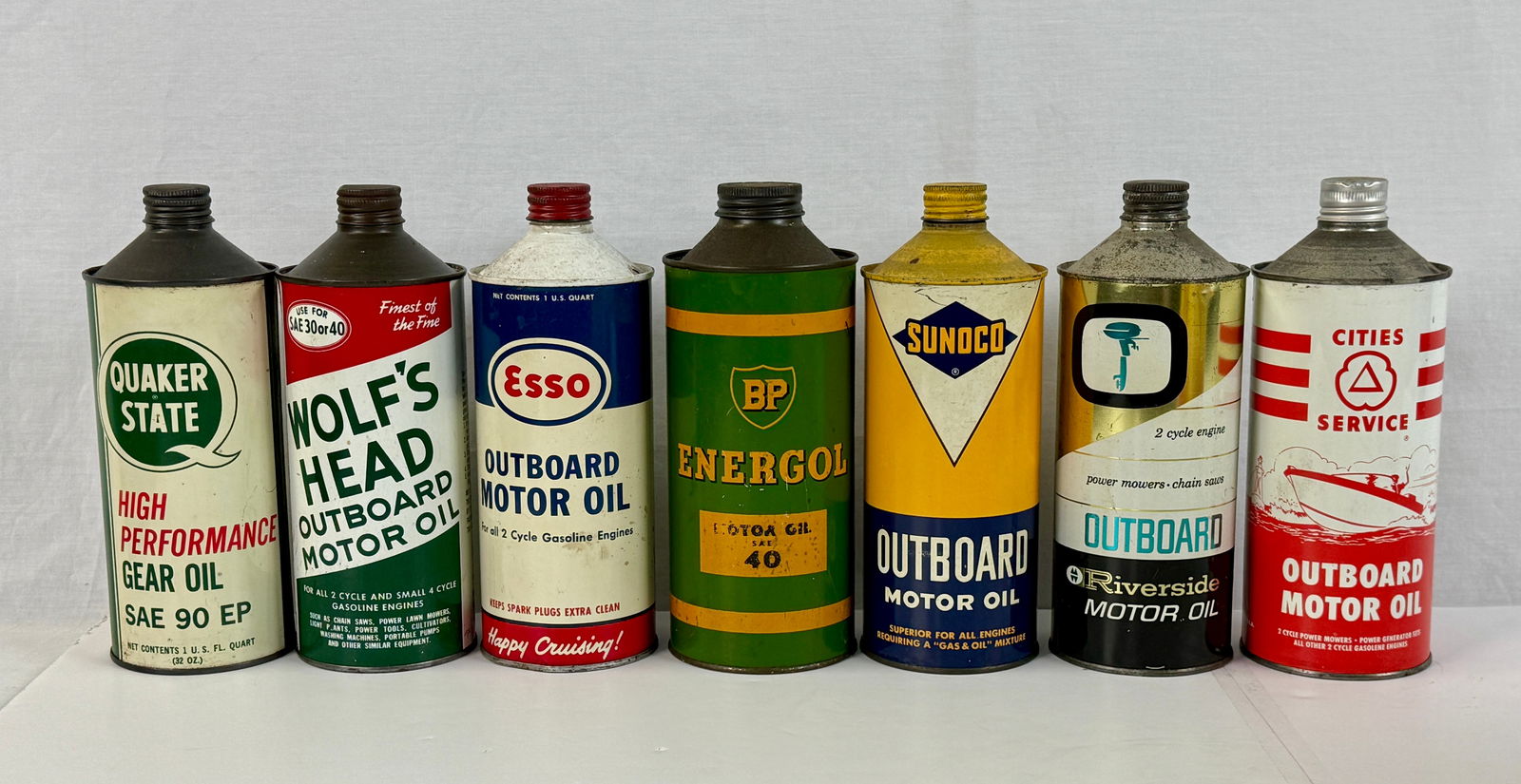 A Collection of Seven Vintage Multi-Colored Metal Oil Cans (1 of 2)