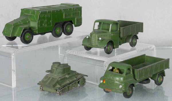 4 DINKY MILITARY VEHICLES: 677 Armoured Command Vehicle, paint chipped, 25WM Bedford, 2 tires cracked, 152A Light Tank, antenna broken, rust on base, 621 3-ton Army Wagon, rust on baseplate, axles & hitch, C5-6.